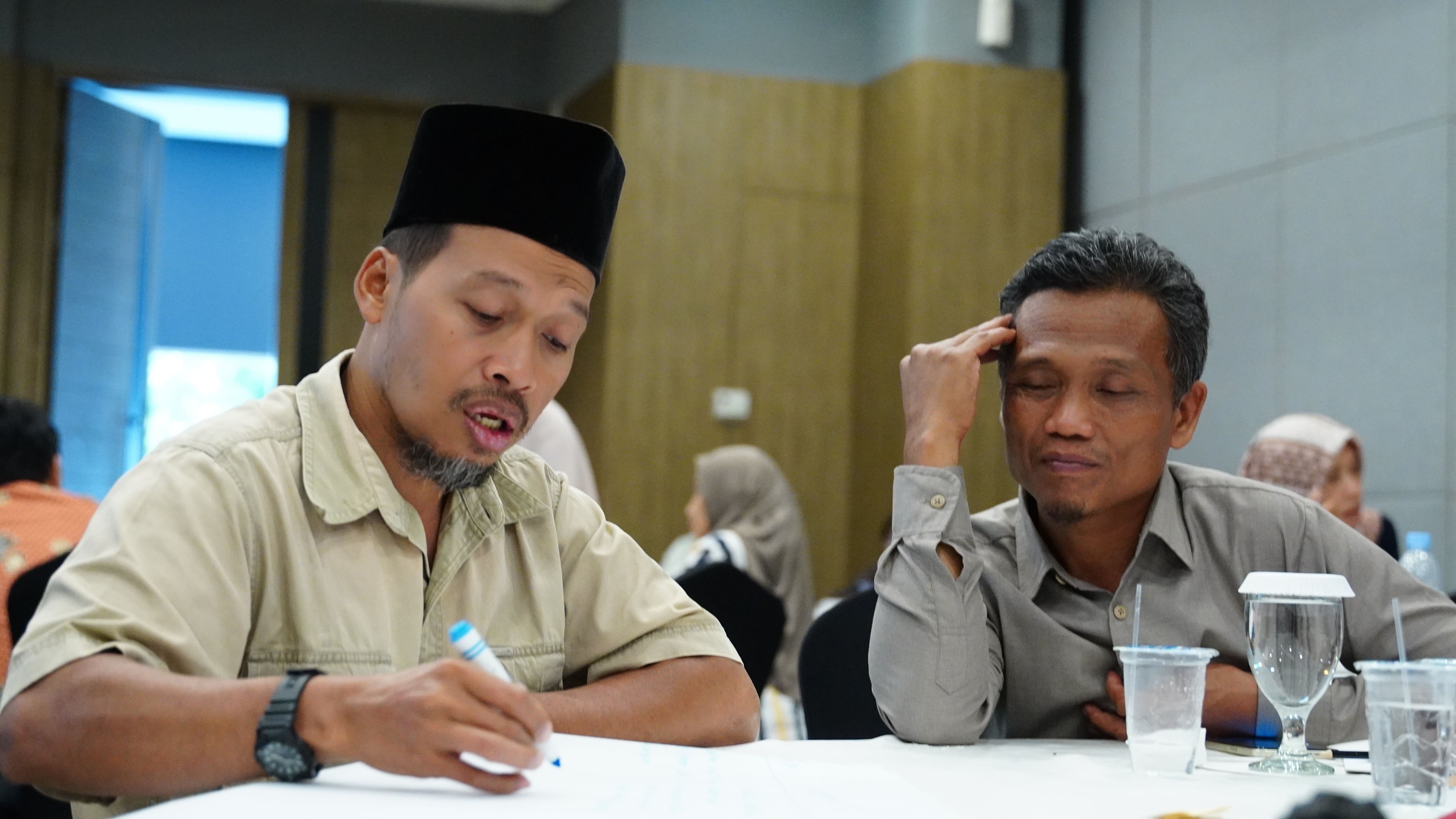 Participant sharing reflection with peers