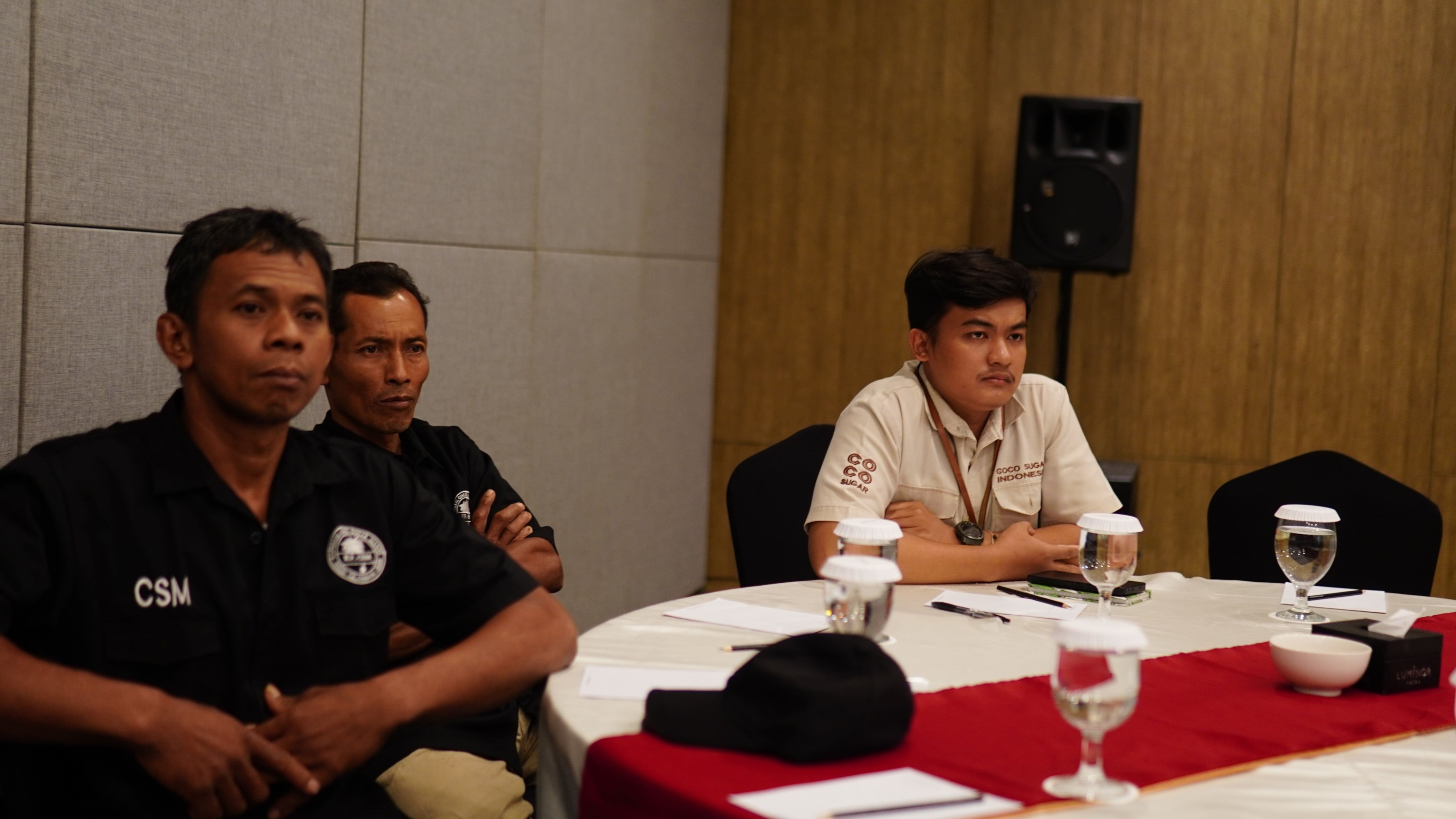 Individuals analysing sticky-note boards